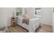 Well-lit bedroom with hardwood floors, windows, and a cozy aesthetic at 617 Scotland St, Dunedin, FL 34698