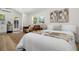 Bedroom with a bed and sofa in a bright and airy space with an exterior door at 617 Scotland St, Dunedin, FL 34698