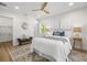 Bright bedroom featuring a ceiling fan, natural light, and an ensuite walk-in closet at 617 Scotland St, Dunedin, FL 34698