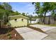 A new landscaping project and an exterior view of the back of the house at 617 Scotland St, Dunedin, FL 34698