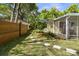 Charming home with mature trees, a well-manicured lawn, and cozy front porch at 617 Scotland St, Dunedin, FL 34698