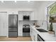 Bright kitchen featuring stainless steel appliances, quartz countertop and white cabinets at 617 Scotland St, Dunedin, FL 34698