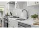 Updated kitchen with stainless steel appliances, modern faucet and white marble countertops at 617 Scotland St, Dunedin, FL 34698