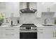Modern kitchen featuring white cabinets, stainless steel appliances and a marble backsplash at 617 Scotland St, Dunedin, FL 34698