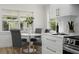 Eat-in kitchen featuring a round table, stainless steel appliances, and modern backsplash at 617 Scotland St, Dunedin, FL 34698