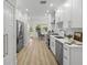 Modern kitchen features stainless steel appliances, white cabinetry, and hardwood flooring at 617 Scotland St, Dunedin, FL 34698