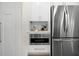 Kitchen features stainless steel appliances, white cabinets and a microwave at 617 Scotland St, Dunedin, FL 34698