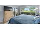 Bedroom featuring a large window with sliding glass door, offering outdoor views at 6269 Palma Del Mar S Blvd # 112, St Petersburg, FL 33715