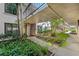 Lush courtyard walkway with beautiful landscaping leads to the front door, offering a serene approach to the residence at 6269 Palma Del Mar S Blvd # 112, St Petersburg, FL 33715