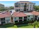 Condos and complex with lush green lawn and parking lot with balconies on a bright, sunny day at 6269 Palma Del Mar S Blvd # 112, St Petersburg, FL 33715