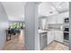 Efficient kitchen featuring stainless steel appliances and a convenient pass-through to the living area, perfect for modern living at 6269 Palma Del Mar S Blvd # 112, St Petersburg, FL 33715