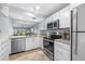 Modern kitchen with stainless steel appliances and opening to the living room at 6269 Palma Del Mar S Blvd # 112, St Petersburg, FL 33715