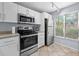 Well-lit kitchen featuring stainless steel appliances, tile floors, and a window for natural light at 6269 Palma Del Mar S Blvd # 112, St Petersburg, FL 33715
