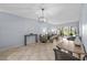 Open concept living room features tile flooring, contemporary furnishings, and sliding glass doors to patio at 6269 Palma Del Mar S Blvd # 112, St Petersburg, FL 33715