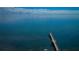 Breathtaking aerial shot of a dock stretching into serene waters with clear skies and distant landmarks at 650 Pinellas Point S Dr # 216, St Petersburg, FL 33705