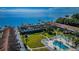 Beautiful aerial view of waterfront condos with a pool, lawn, docks, and bay views with a bridge in the background at 650 Pinellas Point S Dr # 216, St Petersburg, FL 33705