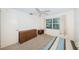A bedroom featuring a ceiling fan, a window looking out onto the lawn, and a dresser at 650 Pinellas Point S Dr # 216, St Petersburg, FL 33705