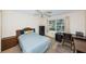 Inviting bedroom with a comfortable bed, neutral carpet, and a window providing natural light at 650 Pinellas Point S Dr # 216, St Petersburg, FL 33705