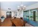 Dining area adjacent to living room with sliding doors to patio and backyard view. Furnished with wooden table at 650 Pinellas Point S Dr # 216, St Petersburg, FL 33705