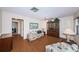 Comfortable living room with wood floors, floral sofa, ceiling fan, and natural light at 650 Pinellas Point S Dr # 216, St Petersburg, FL 33705