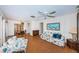 Cozy living room with ceiling fan, wood floors, comfortable furniture, and natural light at 650 Pinellas Point S Dr # 216, St Petersburg, FL 33705