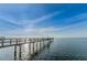 Picturesque view of a wooden pier extending into calm water, perfect for peaceful strolls and enjoying stunning sunsets at 650 Pinellas Point S Dr # 216, St Petersburg, FL 33705