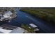 Picturesque aerial view of a waterfront community with lush greenery and a boat speeding down the canal at 6505 Bimini Ct, Apollo Beach, FL 33572