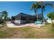 Backyard featuring an inviting screened lanai and lush landscaping at 6505 Bimini Ct, Apollo Beach, FL 33572