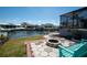 Inviting backyard features a fire pit and canal access, perfect for outdoor relaxation and waterfront living at 6505 Bimini Ct, Apollo Beach, FL 33572