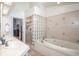 Bright bathroom featuring a walk-in glass block shower and soaking tub at 6505 Bimini Ct, Apollo Beach, FL 33572