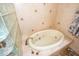 Relaxing bathroom with soaking tub and glass block window for natural light and privacy at 6505 Bimini Ct, Apollo Beach, FL 33572