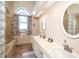 Bright bathroom with double vanity, soaking tub, glass block window and designer fixtures at 6505 Bimini Ct, Apollo Beach, FL 33572