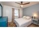 Cozy bedroom with ceiling fan, window with curtains, neutral walls, and carpet flooring at 6505 Bimini Ct, Apollo Beach, FL 33572