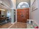 Grand front entrance features elegant double doors and arched transom window with tiled floors at 6505 Bimini Ct, Apollo Beach, FL 33572