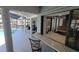 Outdoor kitchen pass-through with granite countertop and views of the screened-in lanai at 6505 Bimini Ct, Apollo Beach, FL 33572