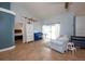 Cozy living room area with blue accents, sliding doors to patio, and tile floors at 6505 Bimini Ct, Apollo Beach, FL 33572