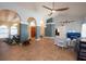 Open living room featuring blue accent walls, arched doorways, and stylish decor, perfect for entertaining at 6505 Bimini Ct, Apollo Beach, FL 33572