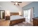 Spacious main bedroom with vaulted ceiling, wood furniture, and a sliding glass door at 6505 Bimini Ct, Apollo Beach, FL 33572