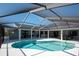 Relaxing backyard with screened-in pool area, covered patio, bar, and outdoor seating perfect for entertaining at 6505 Bimini Ct, Apollo Beach, FL 33572