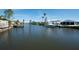 Wide waterfront canal with boat dock, lift and boat under cover on a sunny day at 6505 Bimini Ct, Apollo Beach, FL 33572