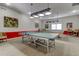 Fun game room featuring a ping pong table, pool table, and comfortable seating for entertainment at 6650 Sunset Way # 118, St Pete Beach, FL 33706