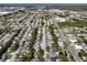 Aerial view of a dense residential area with trees and roadways leading to the ocean at 7014 Westcott Dr, Port Richey, FL 34668
