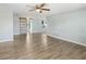 Spacious living room has wood-look floors and a view into the kitchen and dining areas at 7014 Westcott Dr, Port Richey, FL 34668