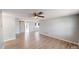 Bright living room with light gray walls, modern ceiling fan, and sliding barn door at 7014 Westcott Dr, Port Richey, FL 34668
