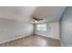 Living room with wood-look floors, natural light and a ceiling fan at 7014 Westcott Dr, Port Richey, FL 34668