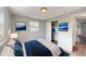 A cozy bedroom featuring a comfortable bed, closet, and stylish artwork on the walls at 7014 Westcott Dr, Port Richey, FL 34668