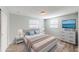 Cozy bedroom featuring a large bed, stylish nightstands, and a modern dresser at 7014 Westcott Dr, Port Richey, FL 34668