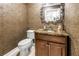 Elegant powder room with granite countertop, stylish fixtures, and patterned wallpaper at 750 4Th Avenue South # 601H, St Petersburg, FL 33701