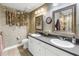 Charming bathroom featuring double sinks, framed mirrors, and designer wallpaper and accents at 750 4Th Avenue South # 601H, St Petersburg, FL 33701