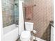 Stylish bathroom with patterned wallpaper, tub with shower, and contemporary fixtures at 750 4Th Avenue South # 601H, St Petersburg, FL 33701